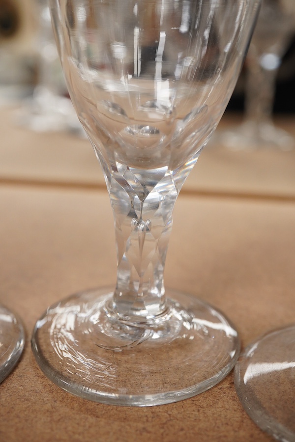 Four Georgian wine glasses, three with engraved bowls, three with faceted stems, and one with an air twist knopped stem and stepped foot, tallest 16cm
